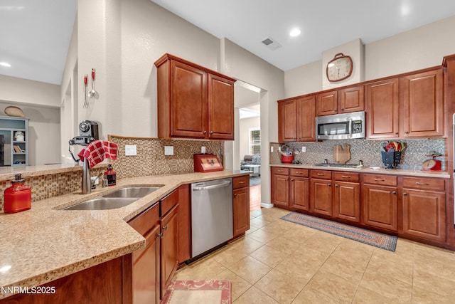 4883 Brunello Dr, Sparks, NV 89436 - kitchen with appliances with stainless steel finishes, decorative backsplash, light stone countertops, light tile patterned flooring, and recessed lighting