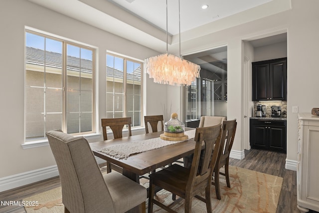 5427 Salmon River Ct, Reno, NV 89511 - dining room featuring a chandelier, dark wood-style flooring, a tray ceiling, recessed lighting, and bar