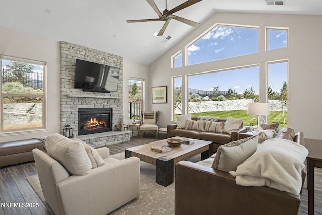 5427 Salmon River Ct, Reno, NV 89511 - living room featuring a ceiling fan, plenty of natural light, a stone fireplace, wood finished floors, and high vaulted ceiling