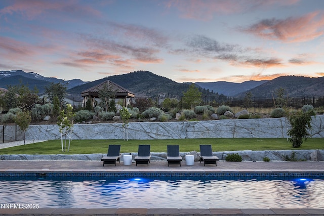 5427 Salmon River Ct, Reno, NV 89511 - pool at dusk featuring a gazebo and a mountain view