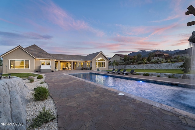 5427 Salmon River Ct, Reno, NV 89511 - pool at dusk featuring a patio area