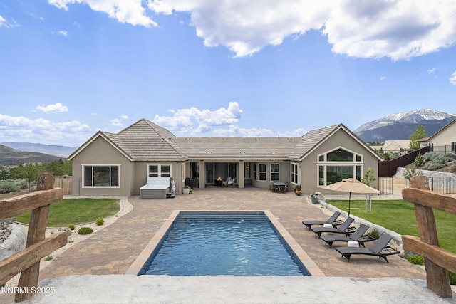 5427 Salmon River Ct, Reno, NV 89511 - back of house featuring a patio, a mountain view, stucco siding, and a tiled roof