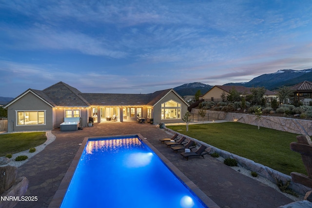 5427 Salmon River Ct, Reno, NV 89511 - pool at dusk featuring a patio and a mountain view
