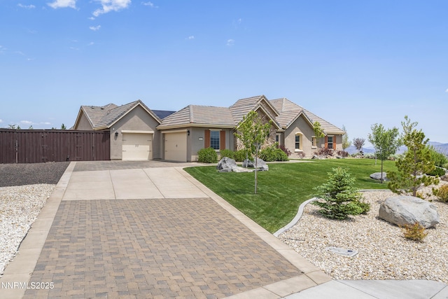 5427 Salmon River Ct, Reno, NV 89511 - ranch-style house featuring a garage, stucco siding, concrete driveway, a front lawn, and a tile roof