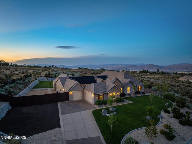 5427 Salmon River Ct, Reno, NV 89511 - traditional-style house featuring a garage, driveway, a mountain view, and roof mounted solar panels