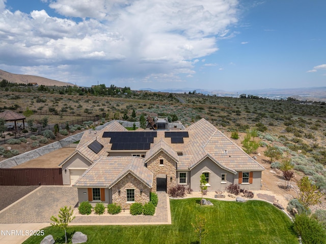 5427 Salmon River Ct, Reno, NV 89511 - view of front of home featuring stone siding, stucco siding, roof mounted solar panels, a front yard, and a tiled roof