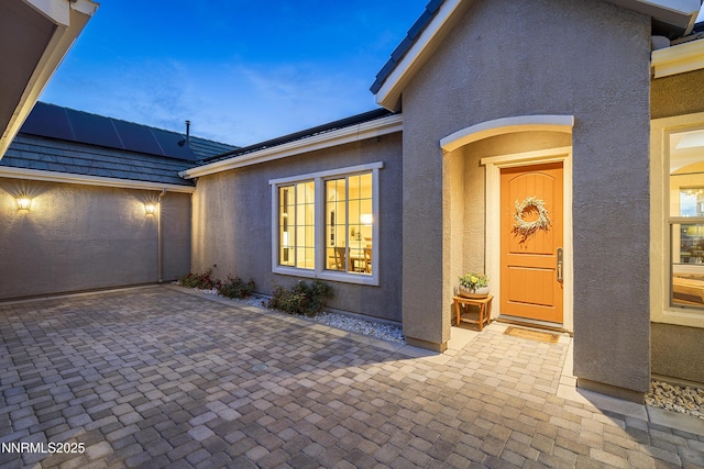5427 Salmon River Ct, Reno, NV 89511 - property entrance with stucco siding and roof mounted solar panels