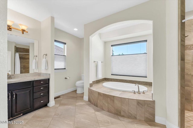 1636 Robb Dr, Carson City, NV 89703 - full bath featuring healthy amount of natural light, vanity, a garden tub, and tiled shower