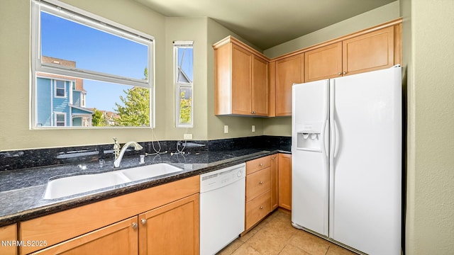 225 Gramercy Ln, Reno, NV 89509 - kitchen with white appliances, dark stone countertops, and light tile patterned floors