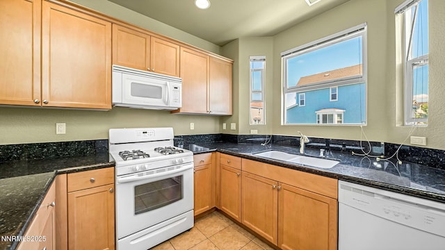225 Gramercy Ln, Reno, NV 89509 - kitchen featuring white appliances, dark stone countertops, light tile patterned floors, and light brown cabinetry