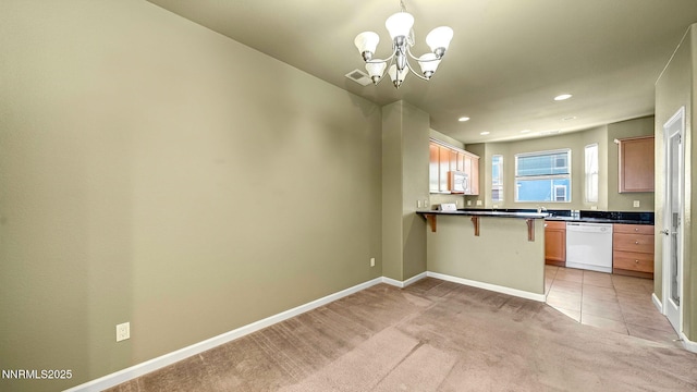 225 Gramercy Ln, Reno, NV 89509 - kitchen with white appliances, light colored carpet, a chandelier, a breakfast bar, and dark countertops