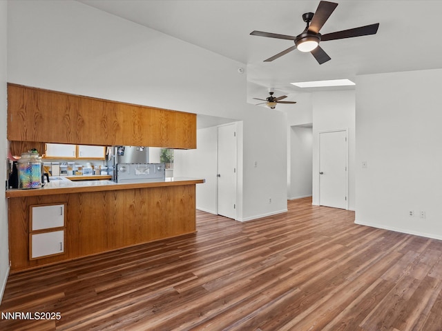 431 Michael Dr, Fallon, NV 89406 - kitchen featuring brown cabinets, a ceiling fan, freestanding refrigerator, dark wood-style floors, and high vaulted ceiling