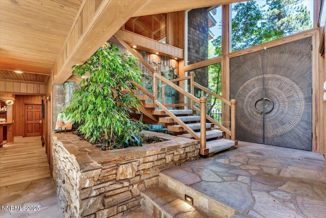 1263 Hidden Woods Dr, Zephyr Cove, NV 89413 - entryway featuring stone finish flooring, stairs, wooden ceiling, and wood walls