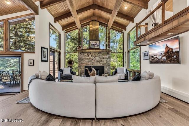 1263 Hidden Woods Dr, Zephyr Cove, NV 89413 - living area with high vaulted ceiling, a wood ceiling with exposed beams, a stone fireplace, and wood finished floors