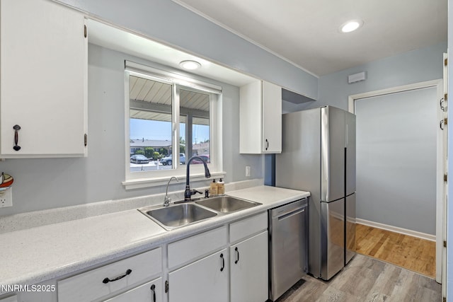 640 Nadine Dr, Fallon, NV 89406 - kitchen featuring appliances with stainless steel finishes, white cabinets, light wood-style flooring, light countertops, and recessed lighting