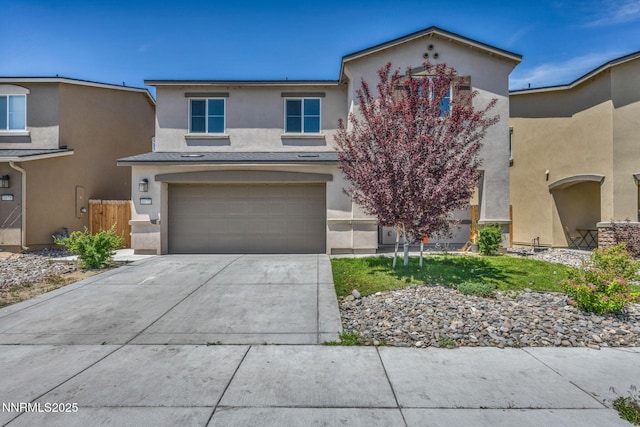 8977 Sagemoor Dr, Reno, NV 89506 - view of front facade featuring stucco siding, driveway, and an attached garage