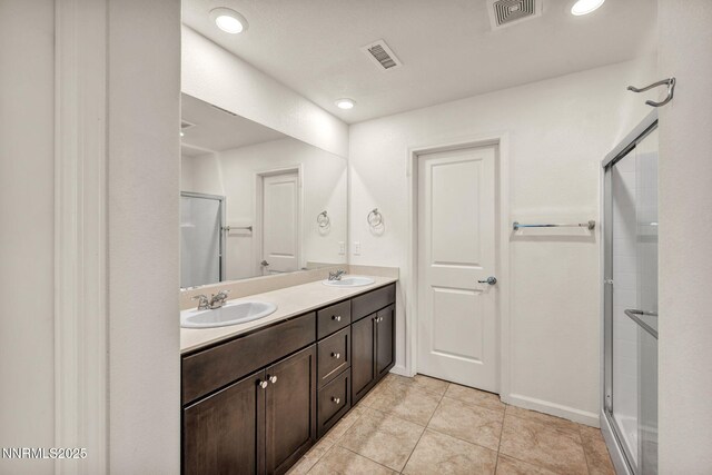8977 Sagemoor Dr, Reno, NV 89506 - bathroom with a stall shower, double vanity, and tile patterned flooring