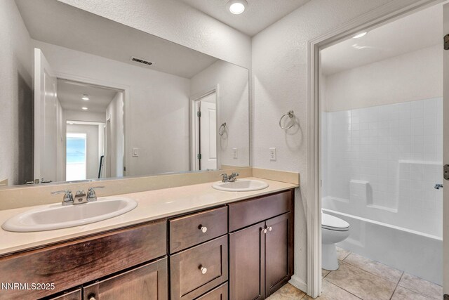 8977 Sagemoor Dr, Reno, NV 89506 - full bathroom with double vanity, tile patterned floors, and shower / tub combination