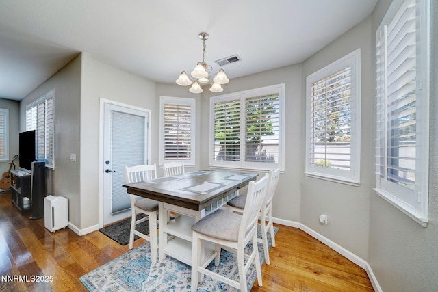 1575 Canyonlands Ct, Reno, NV 89521 - dining space featuring a chandelier, wood finished floors, and plenty of natural light