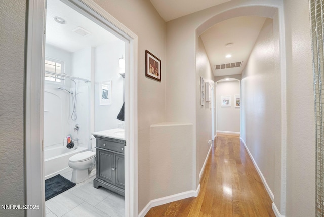 1575 Canyonlands Ct, Reno, NV 89521 - hallway featuring arched walkways and light wood-style floors