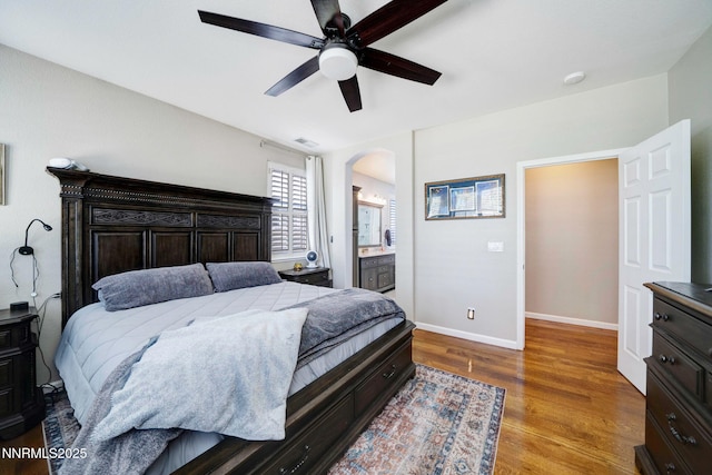 1575 Canyonlands Ct, Reno, NV 89521 - bedroom with wood finished floors, arched walkways, ceiling fan, and ensuite bath