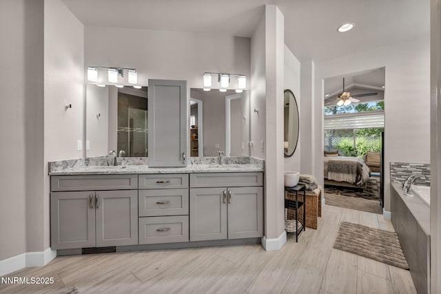 6161 Wycliffe Cir, Reno, NV 89519 - ensuite bathroom with double vanity, ceiling fan, a bath, tiled shower, and wood finished floors