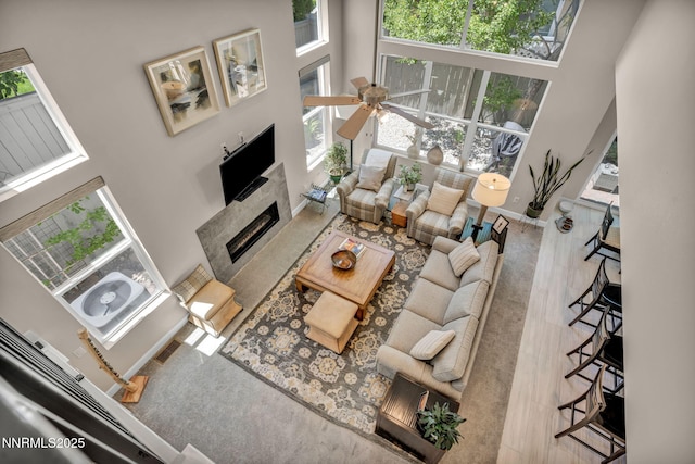 6161 Wycliffe Cir, Reno, NV 89519 - living area featuring a towering ceiling, a tiled fireplace, and ceiling fan