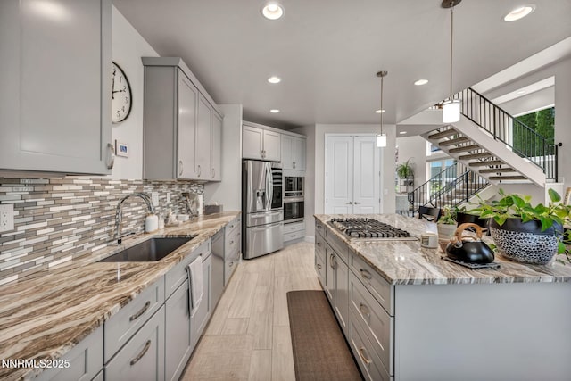 6161 Wycliffe Cir, Reno, NV 89519 - kitchen featuring stainless steel appliances, gray cabinets, light stone counters, backsplash, and recessed lighting