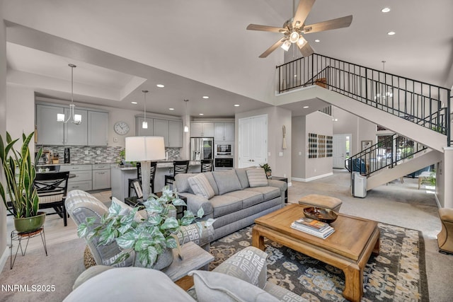 6161 Wycliffe Cir, Reno, NV 89519 - living area featuring stairway, recessed lighting, a towering ceiling, ceiling fan, and light carpet