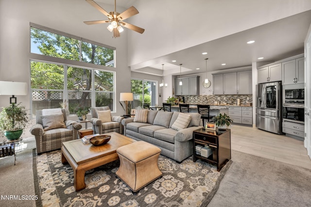 6161 Wycliffe Cir, Reno, NV 89519 - living area featuring ceiling fan, a high ceiling, recessed lighting, and light carpet