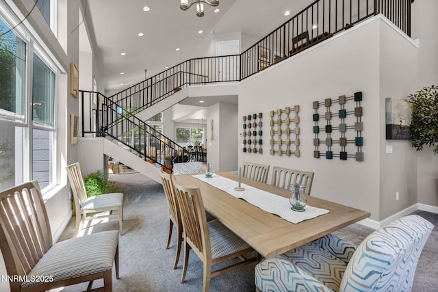 6161 Wycliffe Cir, Reno, NV 89519 - dining space featuring a towering ceiling, carpet flooring, recessed lighting, stairs, and a chandelier