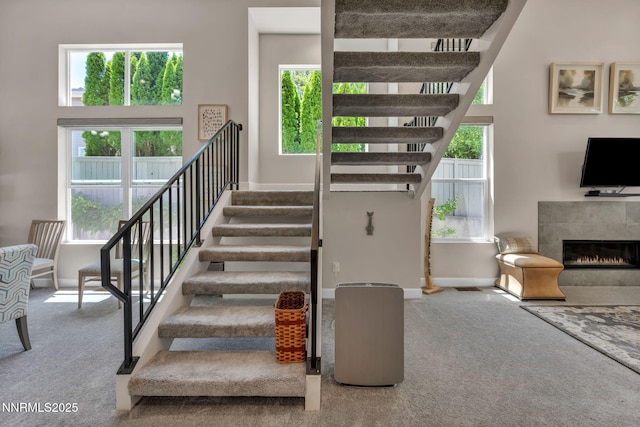 6161 Wycliffe Cir, Reno, NV 89519 - stairway featuring carpet and a tiled fireplace