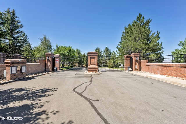 6161 Wycliffe Cir, Reno, NV 89519 - view of asphalt street with a gate, curbs, a gated entry, and sidewalks