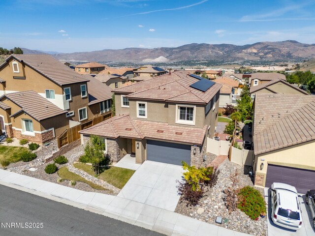 14144 American Pillar Ct, Reno, NV 89511 - view of front of home featuring stucco siding, a residential view, a gate, and stone siding
