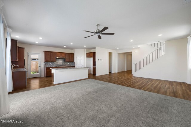 14144 American Pillar Ct, Reno, NV 89511 - unfurnished living room with a ceiling fan, stairway, dark colored carpet, recessed lighting, and dark wood-type flooring
