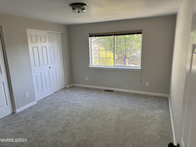 8 Conner Way, Gardnerville, NV 89410 - unfurnished bedroom with carpet flooring, a closet, and a textured ceiling
