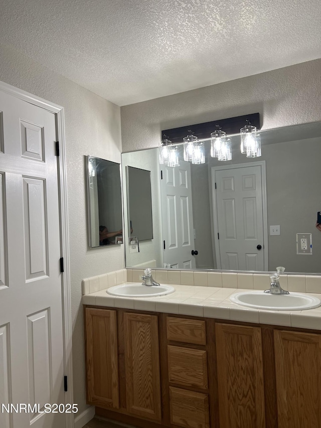 8 Conner Way, Gardnerville, NV 89410 - full bathroom featuring double vanity, a textured wall, and a textured ceiling