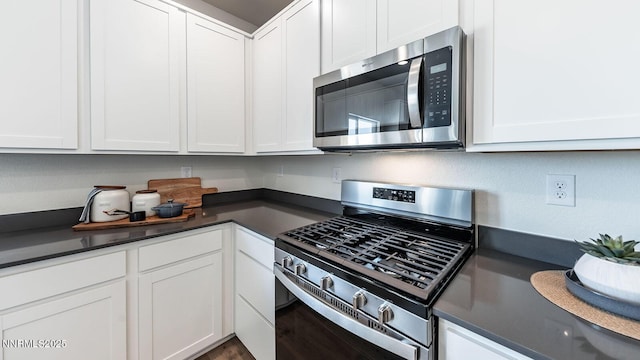 7602 Apex Pl # 106, Reno, NV 89506 - kitchen with appliances with stainless steel finishes, dark countertops, and white cabinetry