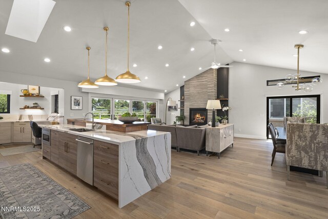 10594 Dixon Ln, Reno, NV 89511 - kitchen featuring modern cabinets, dishwasher, high vaulted ceiling, a spacious island, and a fireplace