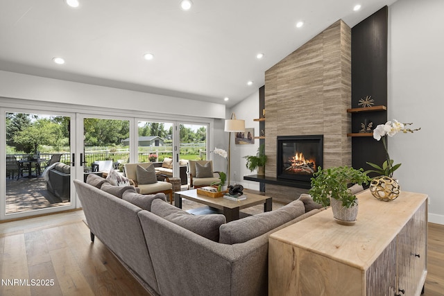 10594 Dixon Ln, Reno, NV 89511 - living room featuring a tile fireplace, light wood-style flooring, recessed lighting, and high vaulted ceiling