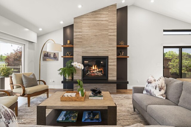 10594 Dixon Ln, Reno, NV 89511 - living room with high vaulted ceiling, a fireplace, plenty of natural light, recessed lighting, and wood finished floors