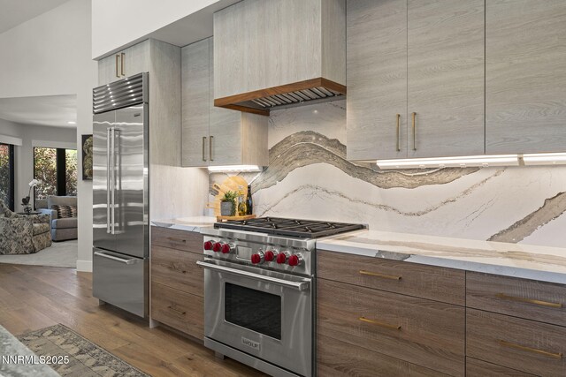 10594 Dixon Ln, Reno, NV 89511 - kitchen with high quality appliances, dark wood-style flooring, modern cabinets, and tasteful backsplash