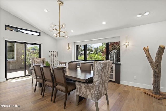 10594 Dixon Ln, Reno, NV 89511 - dining room with light wood-type flooring, a chandelier, vaulted ceiling, and recessed lighting