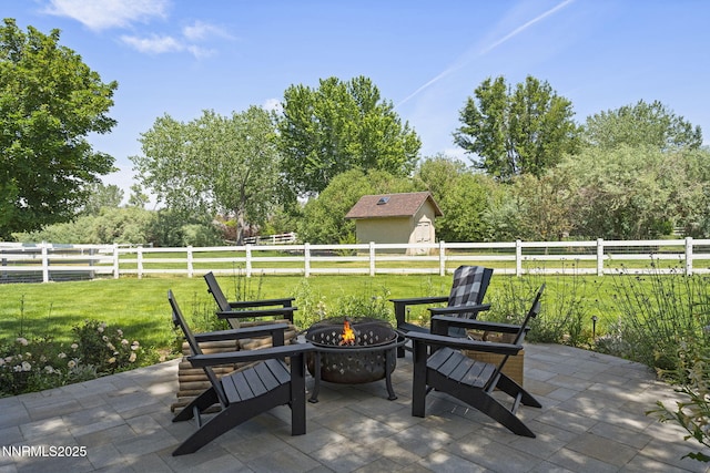 10594 Dixon Ln, Reno, NV 89511 - fenced backyard featuring a fire pit, a patio area, a storage shed, and a rural view