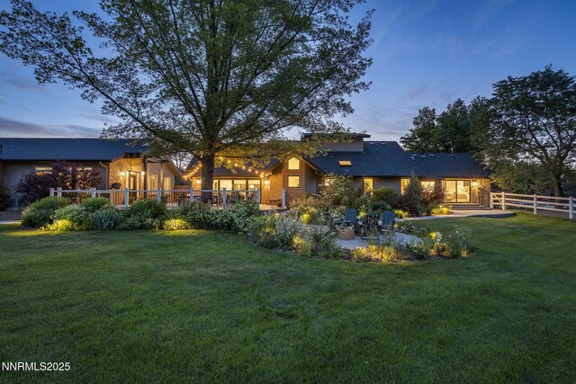 10594 Dixon Ln, Reno, NV 89511 - back of property at dusk featuring a patio area
