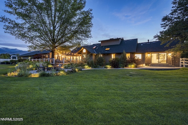 10594 Dixon Ln, Reno, NV 89511 - back of house at dusk with a patio and a mountain view