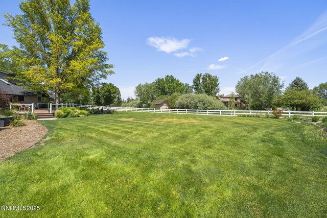 10594 Dixon Ln, Reno, NV 89511 - fenced backyard featuring a wooden deck and a view of rural / pastoral area