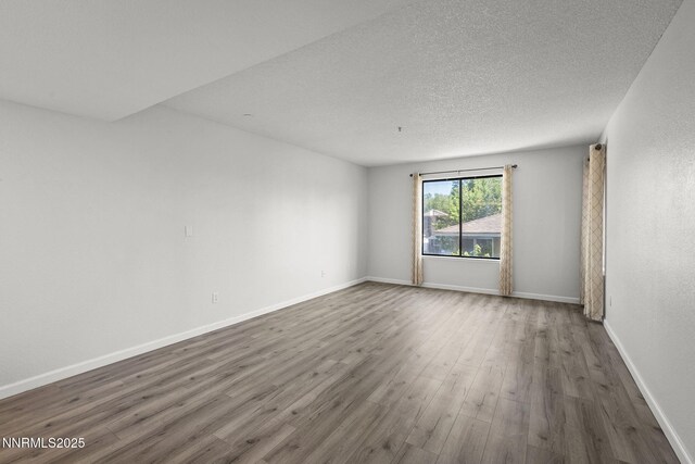 3095 Lakeside Unit 203, Reno, NV 89509 - empty room featuring wood finished floors and a textured ceiling
