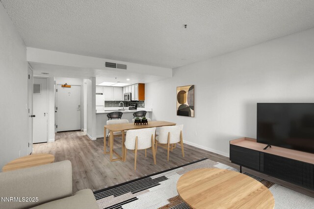 3095 Lakeside Unit 203, Reno, NV 89509 - living room featuring light wood-style floors and a textured ceiling