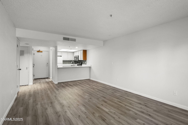 3095 Lakeside Unit 203, Reno, NV 89509 - unfurnished living room with dark wood finished floors and a textured ceiling